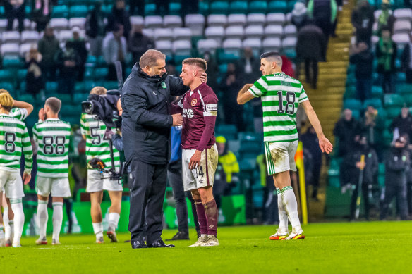 Celtic manager Ange Postecoglou speaks with fellow Australian, Hearts midfielder Cameron Devlin, after beating them 1-0 in December 2021.