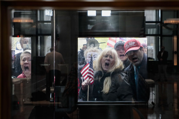 Protesters stand outside a state coronavirus update press conference in Columbus, Ohio. 