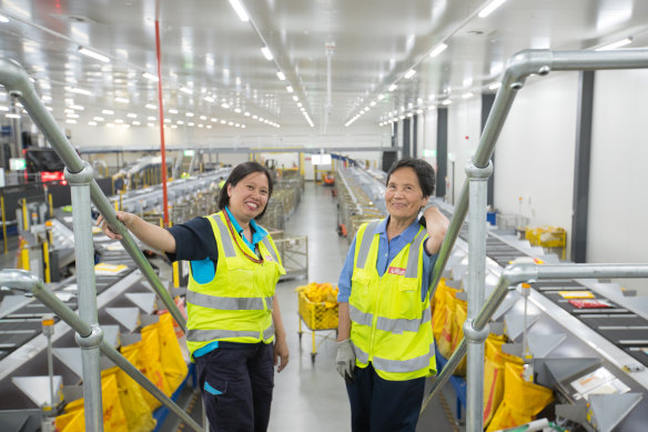 Mother and daughter Gladys Lawang and Cora Andres in their hangar-like workplace.