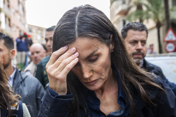 Queen Letizia reacts as she visits people affected by the floods.