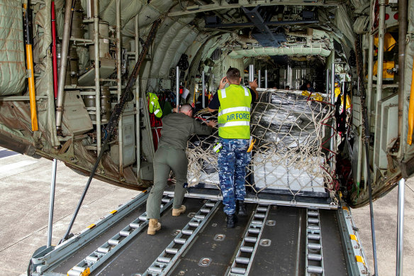A pallet of humanitarian stores is loaded onto a Royal Australian Air Force C130J Hercules transport aircraft at HMAS Albatross, Nowra, New South Wales.