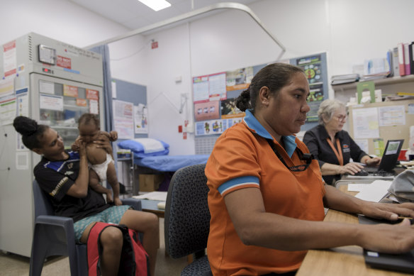 Apunipima health worker Sharlene Williams conducts a check up on six-month-old Juan Ross with his mother Dalassa Johnson.