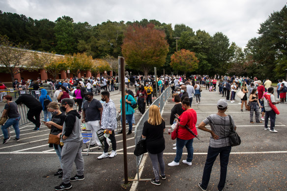 Hundreds of people wait in line for early voting in Marietta, Georgia in October 2020.