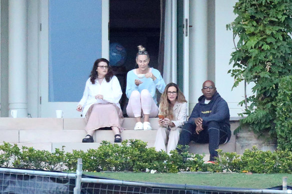 Julia Roberts, second from right, takes in the view from Coolong’s back porch in Vaucluse, much to the delight of the paparazzi on the harbour.