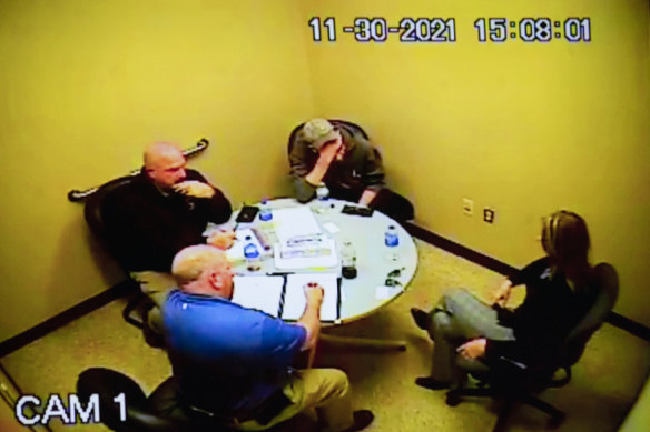 Police footage of James Crumbley, (top-centre) and his wife, Jennifer (right) as they are interviewed by police.