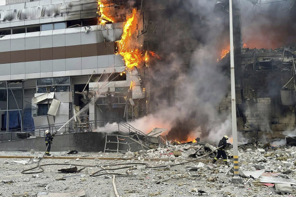 Firefighters work on a site of a building damaged after a Russian attack in Kyiv, Ukraine, on Friday.