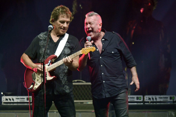 Ian Moss and Jimmy Barnes perform with Cold Chisel at Flemington Racecourse on Friday night.