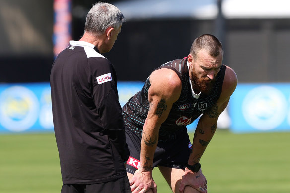 Charlie Dixon talks to the club doctor during Thursday’s training.