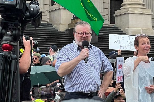 Liberal MP Bernie Finn addressing anti-government protesters at Parliament House last year.