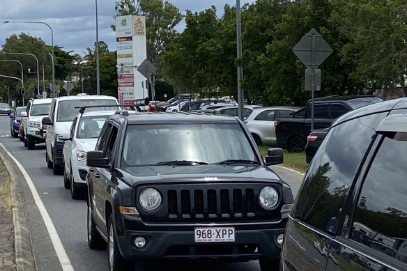 Cars on the grass verge of Beams Road have to reverse into traffic while work proceeds at Carseldine train station.