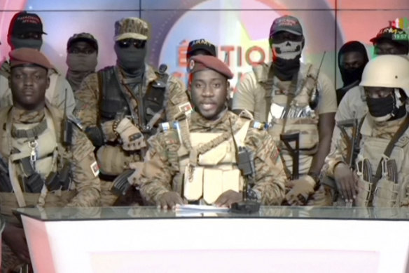 Coup spokesman Captain Kiswendsida Farouk Azaria Sorgho reads a statement in a studio in Ougadougou on Friday.