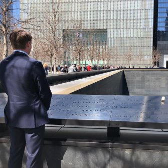 Andrew Hastie visiting the September 11 memorial in New York, standing at the plate that carries the name of Elisa Giselle.