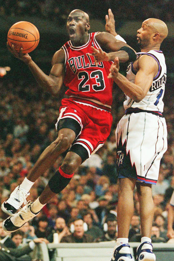 Michael Jordan takes flight against Toronto's Alvin Robertson in 1996.