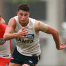 Finn Callaghan of the Giants chases the ball during the AFL practice match between Sydney Swans and Greater Western Sydney Giants.