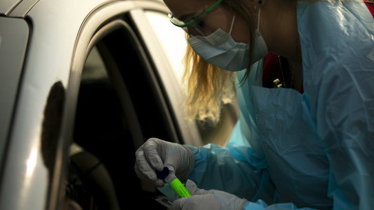 Lindsey Helkenn, a medical lab technician from Spearfish, conducts a COVID-19 test in Sturgis, S.D. 