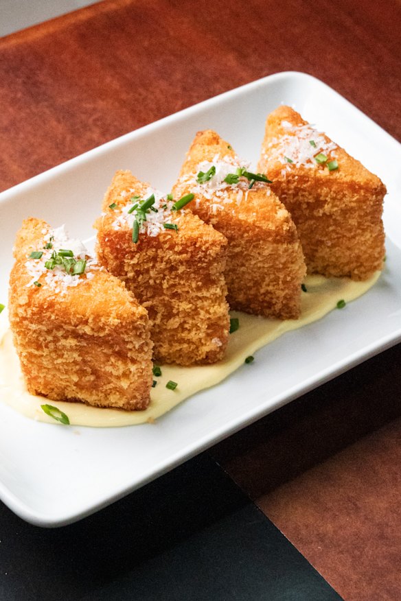 Deep-fried mac and cheese bites with truffle mayo and parmesan.