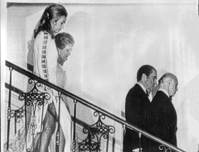 Mrs McMahon and Mrs Nixon follow their husbands downstairs at the White House.