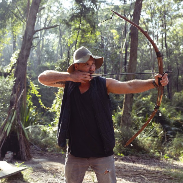 Bushcraft teacher Jake Cassar demonstrating a bow of she-oak he fashioned himself.