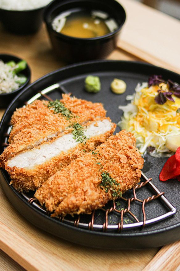 Crumbed pork (tonkatsu) comes with many condiments.