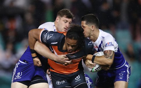 Tigers forward Luciano Leilua is tackled by the Canterbury defence at Leichhardt Oval.