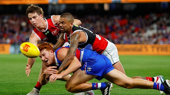 Mattaes Phillipou and Brad Hill exemplify St Kilda’s intensity with a gang-tackle on Ed Richards.