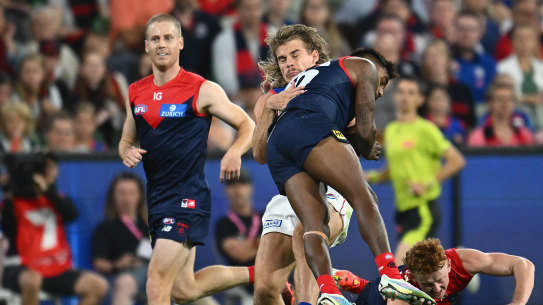 Melbourne’s Kysaiah Pickett ploughs into Bailey Smith on Saturday night at the MCG.