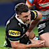 Nathan Cleary is attended to by a trainer. 