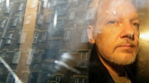 Julian Assange being taken from court last year.