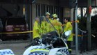 Police and emergency workers stand in front of  Hijab House in Greenacre after a car drove into a shop, injuring 12 people.