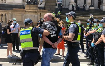Police arrest a man at an anti-lockdown protest outside Victoria's Parliament House on November 3.