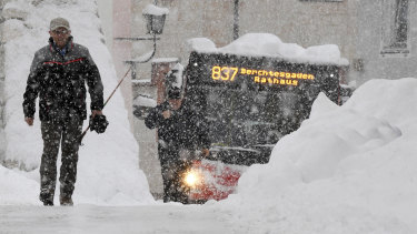 Large parts of southern Germany and Austria have been paralysed by heavy snow.