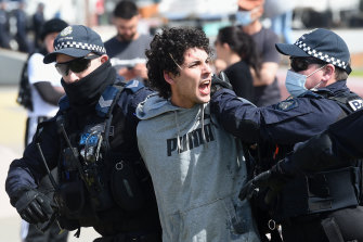 Police arrest a vocal protester on Saturday.