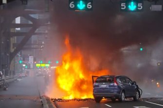 A fire engulfs a car on the Sydney Harbour Bridge on Monday morning.