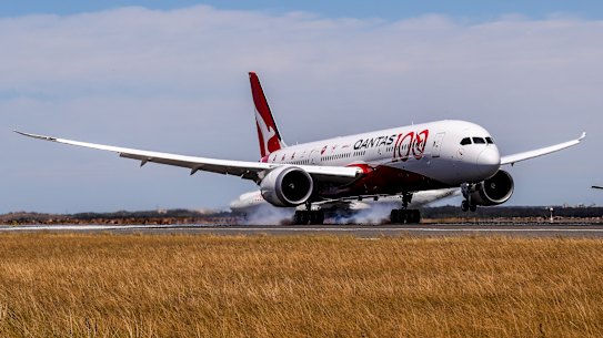 A Qantas flight lands.