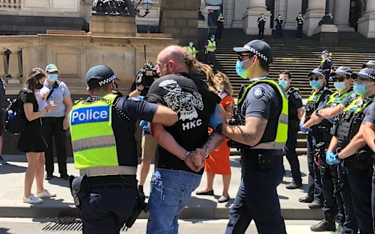 Police arrest a man at an anti-lockdown protest outside Victoria's Parliament House on November 3.