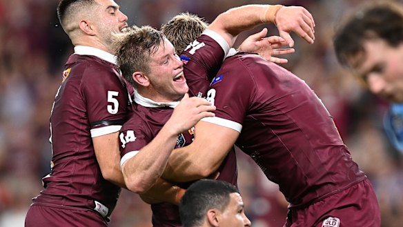 Harry Grant celebrates with Maroons teammates.