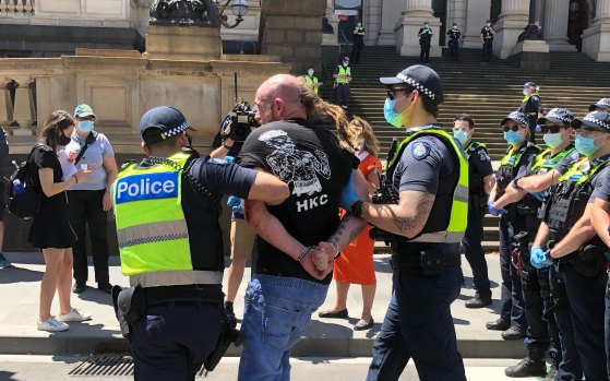 Police arrest a man at an anti-lockdown protest outside Victoria's Parliament House on November 3.