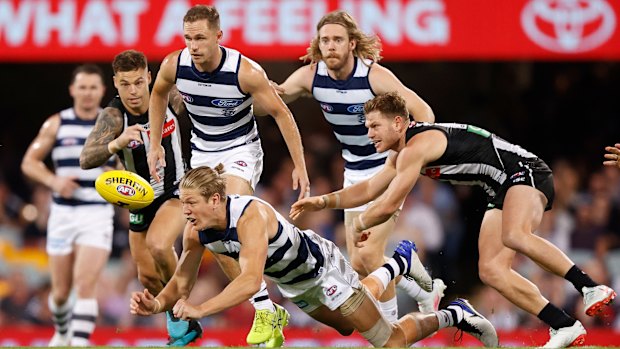 Deep dive: Rhys Stanley attempts a mark under pressure from Collingwood's Taylor Adams (right).