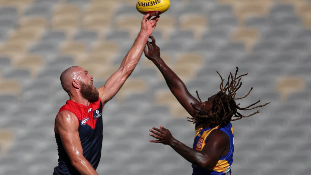 Big men fly: Eagle's Nic Naitanui come up trumps in the highly-anticipated ruck match-up against Melbourne captain Max Gawn.