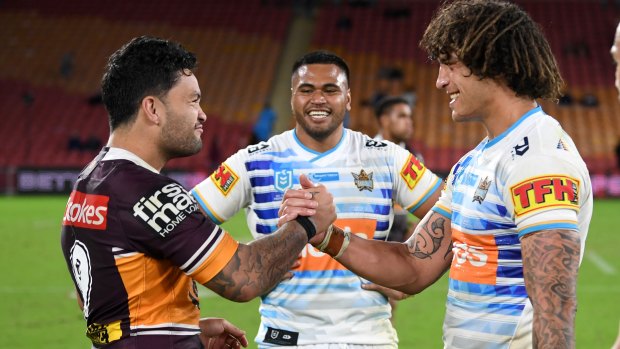 Broncos player Issac Luke shares a laugh with some of his rivals from the Titans last week.