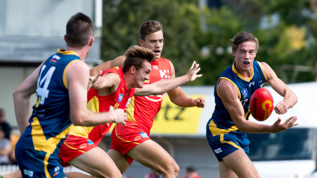 Canberra Demons player Jarrod Osborne, far right, about to pass to Donald Roberts, left, at Alan Ray Oval in Ainslie on Saturday.