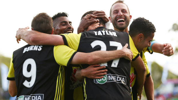 Heading home: Steven Taylor of the Phoenix celebrates with teammates after scoring Wellington's third.
