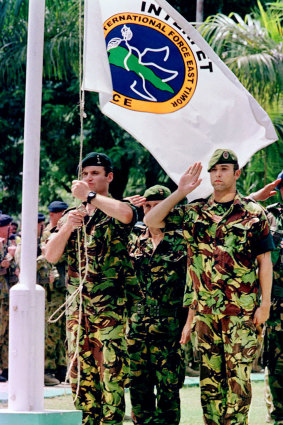 February 14, 2000: Soldiers salute the INTERFET flag as they are relieved by United Nations forces in Dili, capital of East Timor.  