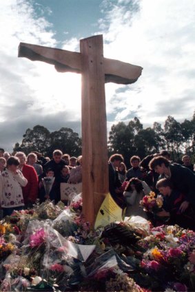 Mourners pay their respects at a memorial site for the 35 victims.