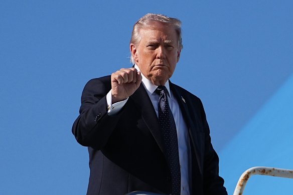 President Donald Trump boards Air Force One at Palm Beach International Airport on Sunday.