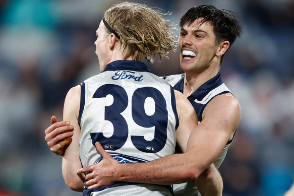 Zach Guthrie and Ollie Henry enjoy a goal during the Cats’ win over Melbourne.