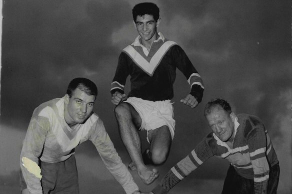 Johnny King using forwards Monty Porter and Bill Wilson as a hurdle during training at Kogarah Oval in 1961.