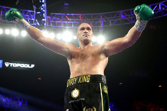 Tyson Fury celebrates after knocking down Deontay Wilder during their heavyweight championship bout in Las Vegas.