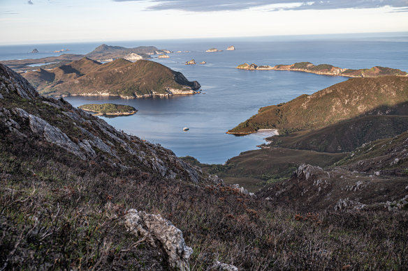 Luxury catamaran Odalisque III in Bramble Cove with the Breaksea Islands beyond. 