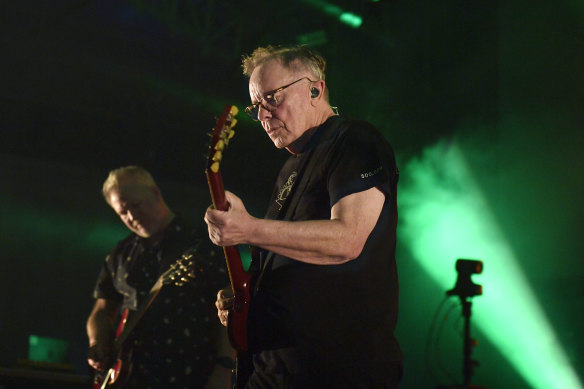 New Order frontman Bernard Sumner, with guitarist Phil Cunningham in the background, at the Sidney Myer Music Bowl on Saturday.